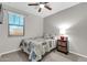 Neutral bedroom features a ceiling fan, carpet, and a window bringing in lots of light at 256 N Jesse St, Chandler, AZ 85225