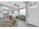 Cozy living room features an olive sofa, ceiling fan, tile floors, and a brightly lit window at 256 N Jesse St, Chandler, AZ 85225