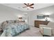 Bright main bedroom features a ceiling fan, wood-look floors, a sitting chair, and an ensuite at 256 N Jesse St, Chandler, AZ 85225