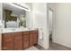 Bathroom features double sinks, wood cabinets, tile floors, and plenty of counter space for daily routines at 28282 N Castle Rock Dr, San Tan Valley, AZ 85143