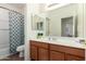 Clean bathroom with a vanity, a large mirror, and a shower-tub combo at 28282 N Castle Rock Dr, San Tan Valley, AZ 85143