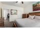 Comfortable bedroom with a wood bed frame, dresser, and bright window, creating a relaxing space at 28282 N Castle Rock Dr, San Tan Valley, AZ 85143