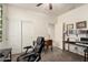 Bright bedroom features neutral walls, carpet flooring, a desk, and a comfortable office chair at 28282 N Castle Rock Dr, San Tan Valley, AZ 85143