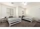 Bedroom with two twin beds, ceiling fan, and side tables offering a comfortable and inviting space at 28282 N Castle Rock Dr, San Tan Valley, AZ 85143