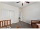 Comfortable bedroom with ceiling fan, closet with sliding doors and crib, creating a serene space at 28282 N Castle Rock Dr, San Tan Valley, AZ 85143