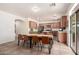 Bright and spacious dining room open to the kitchen with a large table and sliding glass door for outdoor access at 28282 N Castle Rock Dr, San Tan Valley, AZ 85143