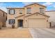 Two story home featuring blue shutters and tan stucco exterior at 28282 N Castle Rock Dr, San Tan Valley, AZ 85143