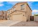 Two story home featuring blue shutters and tan stucco exterior at 28282 N Castle Rock Dr, San Tan Valley, AZ 85143