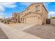 Two story home featuring blue shutters and tan stucco exterior at 28282 N Castle Rock Dr, San Tan Valley, AZ 85143