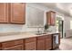 Kitchen features a stainless steel sink and ample countertop space near the window and sliding glass door at 28282 N Castle Rock Dr, San Tan Valley, AZ 85143