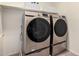 Modern laundry room with a front-loading washer and dryer set at 28282 N Castle Rock Dr, San Tan Valley, AZ 85143