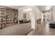 Inviting living room featuring large bookshelves and an archway at 28282 N Castle Rock Dr, San Tan Valley, AZ 85143