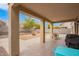 Backyard view with a covered patio, gravel landscaping, and privacy fence at 28282 N Castle Rock Dr, San Tan Valley, AZ 85143