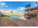 Backyard with a pool, basketball hoop, and an outdoor seating area at 32 W Desert Vista Trl, San Tan Valley, AZ 85143