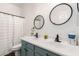 Bathroom with double sinks and a shower with white patterned curtain at 32 W Desert Vista Trl, San Tan Valley, AZ 85143