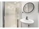 Modern bathroom with a glass-enclosed shower, pedestal sink, and sleek fixtures at 32 W Desert Vista Trl, San Tan Valley, AZ 85143