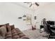 A recreational bedroom setup with sofa, gaming chair and decorative shelves at 32 W Desert Vista Trl, San Tan Valley, AZ 85143