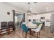 Well-lit dining area with a table for four, sliding glass doors, and an open view to the kitchen at 32 W Desert Vista Trl, San Tan Valley, AZ 85143