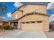 Two-story home featuring a well-manicured yard, covered porch, and a two car garage at 32 W Desert Vista Trl, San Tan Valley, AZ 85143