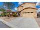 Two-story home featuring a well-manicured yard, covered porch, and a two car garage at 32 W Desert Vista Trl, San Tan Valley, AZ 85143