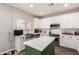 Modern kitchen featuring white cabinets, stainless steel appliances, and a functional center island at 32 W Desert Vista Trl, San Tan Valley, AZ 85143