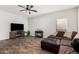 Inviting living room with a corner sofa, wood-look tile flooring, and entertainment center at 32 W Desert Vista Trl, San Tan Valley, AZ 85143