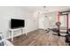 Neutral living room with a wall-mounted TV, workout equipment, and wood-look tile flooring at 32 W Desert Vista Trl, San Tan Valley, AZ 85143