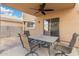 Covered patio with a ceiling fan and a dining table set at 32 W Desert Vista Trl, San Tan Valley, AZ 85143