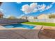 Backyard pool with artificial grass and a concrete surround at 32 W Desert Vista Trl, San Tan Valley, AZ 85143