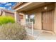 Inviting porch with seating area, decorative railing and a well-maintained landscape at 32 W Desert Vista Trl, San Tan Valley, AZ 85143