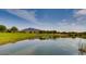 Scenic golf course with a peaceful pond reflecting the clear blue sky above at 33575 N Dove Lakes Dr # 1038, Cave Creek, AZ 85331