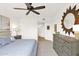 A ceiling fan, desert themed art, and craftsman style furniture fill this comfortable main bedroom at 33575 N Dove Lakes Dr # 1038, Cave Creek, AZ 85331