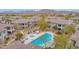 Scenic view of community pool with lounge chairs, umbrellas, and lush landscaping at 33575 N Dove Lakes Dr # 1038, Cave Creek, AZ 85331