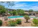 Exterior view of pool with lounge chairs, umbrellas, lush landscaping and seating areas at 33575 N Dove Lakes Dr # 1038, Cave Creek, AZ 85331