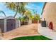 Large backyard features shed storage on a gravel area with an irrigation hose at 3603 E Indigo Bay Ct, Gilbert, AZ 85234