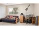 A bedroom with a futon, desk, and guitar on the wall at 3603 E Indigo Bay Ct, Gilbert, AZ 85234