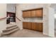 Hallway with upper and lower storage cabinets and a view into the living area at 3603 E Indigo Bay Ct, Gilbert, AZ 85234