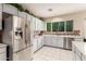 Bright kitchen featuring white cabinets, stainless appliances, and tile backsplash at 3603 E Indigo Bay Ct, Gilbert, AZ 85234