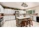 Bright kitchen with a center island, white cabinets, tile floors and stainless appliances at 3603 E Indigo Bay Ct, Gilbert, AZ 85234