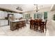 Bright kitchen with a center island, white cabinets, tile floors and stainless appliances at 3603 E Indigo Bay Ct, Gilbert, AZ 85234