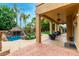 Covered patio and backyard pool oasis featuring an attractive rock waterfall at 3603 E Indigo Bay Ct, Gilbert, AZ 85234