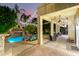 Covered patio overlooking pool with rock waterfall at dusk at 3603 E Indigo Bay Ct, Gilbert, AZ 85234