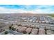 Panoramic aerial view of a residential community with manicured lawns, green spaces, and mountain views at 38208 N La Grange Ln, San Tan Valley, AZ 85140