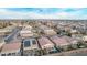 A high aerial view reveals houses with solar panels, inviting pools, and landscaped backyards at 38208 N La Grange Ln, San Tan Valley, AZ 85140