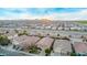 Expansive aerial view of a residential community with desert landscape and mountain views at sunset at 38208 N La Grange Ln, San Tan Valley, AZ 85140