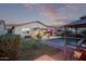 Backyard showcasing a refreshing pool, an outdoor seating area with a gazebo, lush greenery, and cozy ambiance at 38208 N La Grange Ln, San Tan Valley, AZ 85140