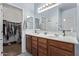 Bathroom with double sink vanity, large mirror, and walk-in closet at 38208 N La Grange Ln, San Tan Valley, AZ 85140