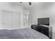 Bedroom featuring sliding door closet, ceiling fan, and a dresser with TV at 38208 N La Grange Ln, San Tan Valley, AZ 85140