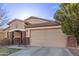 Neat single-story home with a two-car garage, brick and stucco facade, and a landscaped front yard at 38208 N La Grange Ln, San Tan Valley, AZ 85140