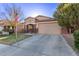 Quaint single-story home with a two-car garage, well-manicured lawn, and a welcoming facade at 38208 N La Grange Ln, San Tan Valley, AZ 85140